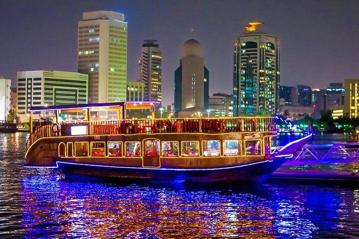 Glide through Dubai Marina on a traditional dhow enjoying a delectable buffet dinner while gazing at illuminated skyscrapers and luxury yachts under the stars. A memorable night awaits.